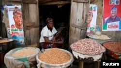 FILE - Latefat Alao, a ethnic Yoruba Muslim woman, waits for customers in Beere market in Ibadan, southwest Nigeria, Jan. 29, 2015.