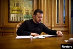 FILE - Ukrainian President Volodymyr Zelenskyy speaks with U.S. House of Representatives Speaker Mike Johnson by phone in Kyiv on March 28, 2024. (Ukrainian Presidential Press Service via Reuters)