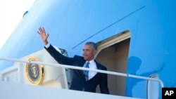 President Barack Obama waves as he boards Air Force One, June 29, 2016, at Andrews Air Force Base, Md. 