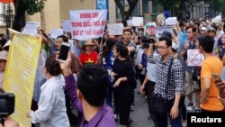 Protesters hold a banner which reads "No Leasing Land to China even for Anytime" during a demonstration against a draft law on the Special Economic Zone in Hanoi, Vietnam, June 10, 2018.