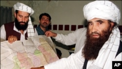 Sirajuddin Haqqani, far left, and Jalaluddin Haqqani, far right, then Taliban Army Supreme Commander, meet with reporters in Miram Shah, Waziristan on Aug. 22, 1998 (file photo).