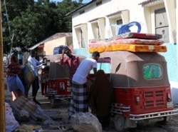 Residents load their belongings into rickshaws as they flee following renewed clashes between rival factions in the security forces, who have split in a dispute over an extension to the president's term, in Mogadishu, Somalia, April 27, 2021.