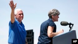 Vice President Mike Pence waves to supporters as U.S. Sen. Joni Ernst, R-Iowa, speaks during her annual fundraiser, June 3, 2017, in Boone, Iowa.