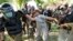 FILE - Police detain a supporter of Pakistan's former Prime Minister Imran Khan who with others was protesting against Khan's arrest, in Lahore, Pakistan, May 10, 2023.
