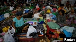 FILE - People displaced in the conflict between Kachin Independence Army (KIA) and Myanmar military for the control of an amber mine pass their time at a Christian church in Tanai township, Kachin state, Myanmar, June 16, 2017.