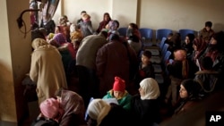 FILE - Syrians waiting for their appointments at the U.N. refugee agency's registration center in Zahleh, in Lebanon's Bekaa Valley.
