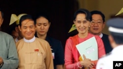 FILE - Win Myint, newly elected president of Myanmar, left, and Myanmar's leader Aung San Suu Kyi leave the parliament in Naypyitaw, Myanmar, March 28, 2018. 