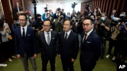 Four lawmakers, from left, Dennis Kwok, Kenneth Leung, Kwok Ka-ki and Alvin Yeung. Hours after these Hong Kong pro-democracy lawmakers were expelled from the city’s legislature, 15 of their colleagues resigned en masse.