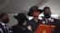 The former first lady of Haiti, Martine Moise, speaks during the funeral of her slain husband, former President Jovenel Moise, accompanied by her children in Cap-Haitien, Haiti, July 23, 2021.