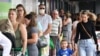 FILE - People line up to enter a grocery store in Brisbane, Australia, Jan. 8, 2021. 
