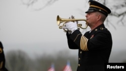 FILE - Taps is played by a lone bugler during the funeral for Korean War veteran Private First Class Glenn Schoenmann in Palmer, Tennessee, January 12, 2013. 
