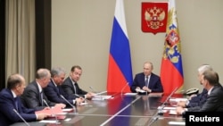 Russian President Vladimir Putin and Prime Minister Dmitry Medvedev attend a meeting with members of the Security Council at the Novo-Ogaryovo state residence outside Moscow, Aug. 5, 2019. (Sputnik/M. Klimentyev/Kremlin) 