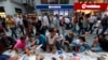 Anti-government protesters eat as they break their fast on the first day of the holy month of Ramadan at Taksim Square in Istanbul, Turkey, July 9, 2013. 
