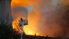 A firefighter uses a hose as Notre Dame cathedral is burning in Paris, April 15, 2019.