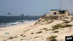 A ship transporting international humanitarian aid is moored at the U.S.-built Trident Pier near Nuseirat in the central Gaza Strip on May 21, 2024.