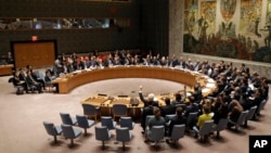 FILE - The United Nations Security Council votes on a resolution during a meeting at U.N. headquarters, March 2, 2016.