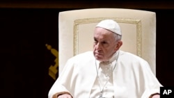 FILE - Pope Francis attends the traditional greetings to the Roman Curia, at the Vatican, Dec. 21, 2018.