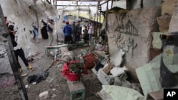 Citizens inspect the scene after a car bomb explosion at a crowded outdoor market in the Iraqi capital's eastern district of Sadr City, Iraq, Jan 2, 2017. 