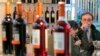 FILE - Visitors try Moldovan wine at an exhibition in Chisinau, Moldova.