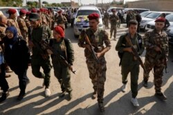 Fighters of Syrian Democratic Forces take part in the funeral procession of Kurdish fighters who were killed during clashes in the northeastern Syrian town of Ras al-Ain, in Qamishli, Syria, Oct. 22, 2019.