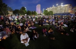 People with candles attend as immigration rights activists hold a "Lights for Liberty" candlelit vigil at Cleveland Square Park in El Paso, Texas, July 12, 2019.
