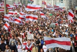 FILE - Opposition supporters take part in a rally against police brutality following protests to reject the presidential election results in Minsk, Belarus, Sept. 13, 2020.