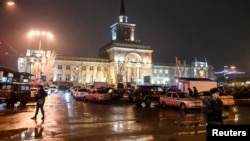 Interior Ministry members stand guard in front of the train station where a bomber detonated explosives in Volgograd, Dec. 29, 2013. 