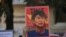 A demonstrator holds up a sign outside the Chinese Embassy as people protest against the military coup and demand the release of elected leader Aung San Suu Kyi, in Yangon, Myanmar, February 11, 2021. REUTERS/Stringer