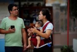 Vararunee Khonchanath, 35, chats with a man in Santa Cruz Church, ahead of Pope Francis' visit to Thailand, in Bangkok, Nov. 14, 2019.