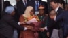 FILE - Tanzania's President Samia Suluhu Hassan, center, receives a bouquet of flowers upon her arrival at Beijing Capital International Airport in Beijing on Sept. 3, 2024, ahead of the Forum on China-Africa Cooperation.