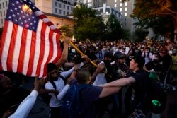 Demonstrators clash as people gather to protest the death of George Floyd, May 30, 2020, near the White House in Washington.