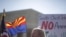 Charles Balogh demonstrates in front of the Supreme Court in Washington as the court holds a hearing on Arizona's "show me your papers" immigration law, April 25, 2012.