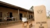 FILE - A sign for Ghana's Electoral Commission is seen at a polling station in Accra during a previous poll.