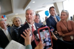Louisiana's Republican gubernatorial candidate Eddie Rispone talks to media on a campaign stop at New Orleans International Airport in Kenner, La., Nov. 4, 2019.