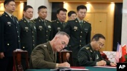 U.S. Chairman of the Joint Chiefs of Staff Joseph Dunford and his Chinese counterpart, chief of the general staff of the Chinese People's Liberation Army Gen. Fang Fenghui, attend a signing ceremony in Beijing, China, Aug. 15, 2017.