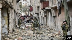 This undated handout photo released, Jan. 2, 2017, by the Russian Defense Ministry claims to show Russian military engineers operating in Aleppo, Syria.