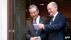 German Chancellor Olaf Scholz and Chinese Foreign Minister Wang Yi shake hands during a bilateral meeting during the 61st Munich Security Conference (MSC) in Munich, Feb. 15, 2025. 