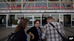 FILE - Travelers wait outside the Irbil International Airport in Iraq, Sept. 29, 2017. 