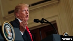 FILE - U.S. President Donald Trump answers a question at the White House in Washington, Jan. 10, 2018.
