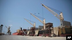FILE - Cargo ship and oil tanker ship are idle at the port of Hodeida, Yemen, Sept. 29, 2018.