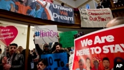 FILE - Immigrant rights advocates demonstrate against President-elect Donald Trump's immigration policies during a rally at Metropolitan AME Church in Washington, Jan. 14, 2017.
