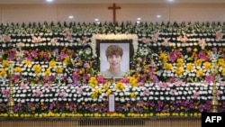 The portrait of Kim Jong-Hyun, a 27-year-old lead singer of the massively popular K-pop boyband SHINee, is seen on a mourning altar at a hospital in Seoul.