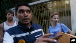 FILE - Alexander Kirillov, left rear, and Anastasia Vashukevich, right, arrive at the immigration detention center, Feb. 28, 2018.