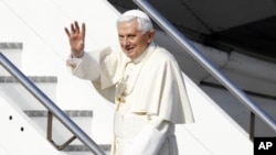 Pope Benedict XVI waves as he boards his plane to leave for his pastoral visit to Mexico and Cuba, at Fiumicino International Airport in Rome, March 23, 2012. 