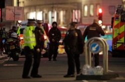Armed police officers stand on the north side of London Bridge in London, Nov. 29, 2019.