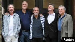 FILE - Members of British comedy troupe Monty Python, from left, Eric Idle, John Cleese, Terry Gilliam, Michael Palin and Terry Jones pose for a photograph during a media event in central London, June 30, 2014. 