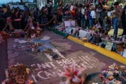 Demonstrators gather around the pavement where George Floyd was murdered outside Cup Foods to celebrate the conviction of former Minneapolis police officer Derek Chauvin in his death, April 20, 2021, in Minneapolis.