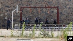 FILE - In this Oct. 8, 2014, photo, police officers take positions by nooses prepared to execute men at a jail in Kabul, Afghanistan. Afghanistan has hanged six men convicted of terrorism, signaling a tougher approach toward the Taliban.