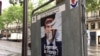 This campaign poster, like many others in Paris, was defaced, May 6, 2017. France's election has been marked by dissatisfaction with both candidates and deep anti-establishment sentiments. (Photo: L. Ramirez/VOA)