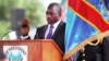 FILE - Incumbent Congo President Joseph Kabila holds the Congolese flag as he takes the oath of office as he is sworn in for another term, in Kinshasa, Democratic Republic of Congo.